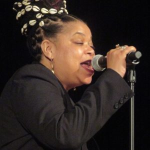 Portrait of Phyllis Kee on stage singing